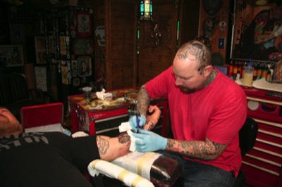  Brandon Notch working away tattooing  